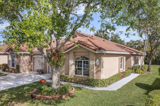 view of front facade featuring a tiled roof, stucco siding, an attached garage, driveway, and a front yard