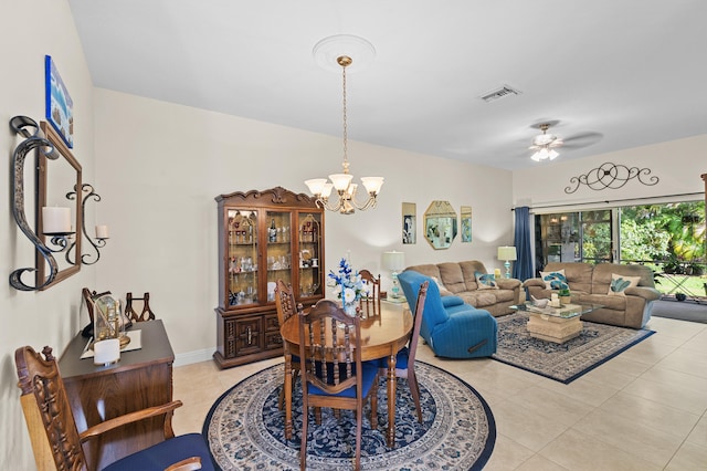 interior space with ceiling fan with notable chandelier, visible vents, and light tile patterned flooring