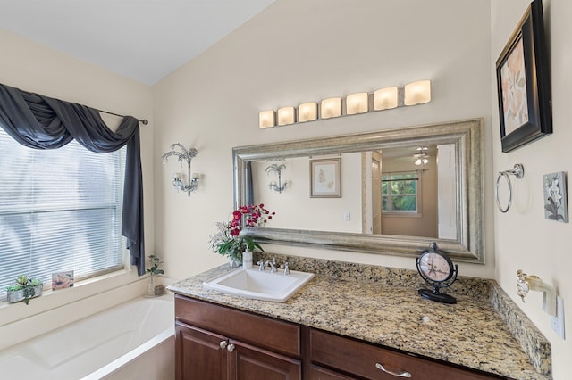 full bath with a bath, vanity, and ceiling fan