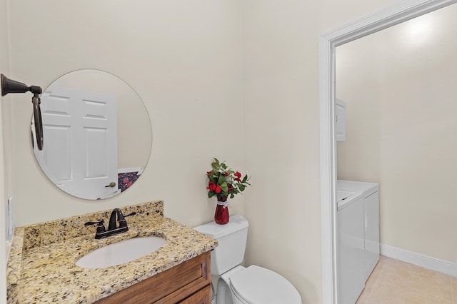 bathroom featuring tile patterned floors, toilet, baseboards, vanity, and washer and dryer
