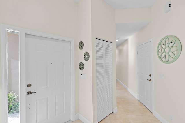 entrance foyer with baseboards and light tile patterned floors