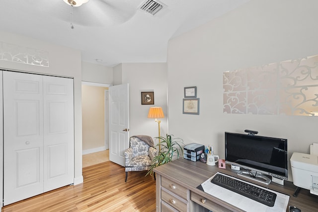 office with baseboards, visible vents, and light wood-type flooring