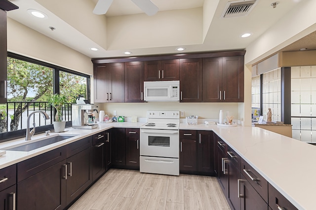 kitchen featuring a ceiling fan, a sink, white appliances, visible vents, and recessed lighting