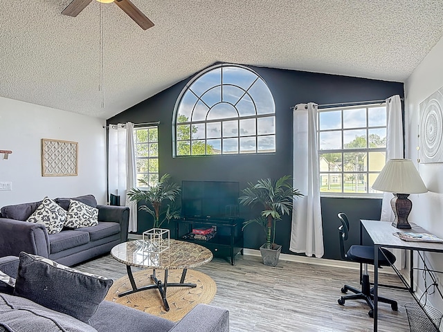 5005 Laguna Bay Cir Unit 26, Kissimmee, FL 34746 - living area featuring wood finished floors, a ceiling fan, a textured ceiling, and vaulted ceiling