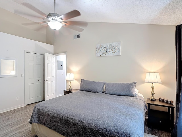 5005 Laguna Bay Cir Unit 26, Kissimmee, FL 34746 - bedroom featuring a textured ceiling, wood finished floors, visible vents, and baseboards