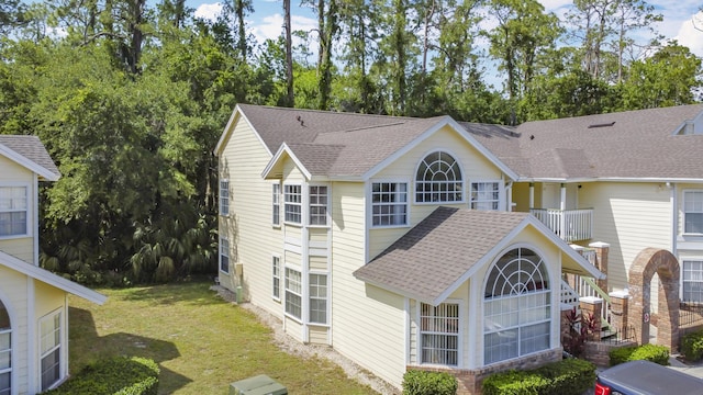 5005 Laguna Bay Cir Unit 26, Kissimmee, FL 34746 - exterior space with a lawn and a shingled roof
