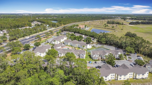 5005 Laguna Bay Cir Unit 26, Kissimmee, FL 34746 - drone / aerial view featuring a water view, a view of trees, and a residential view