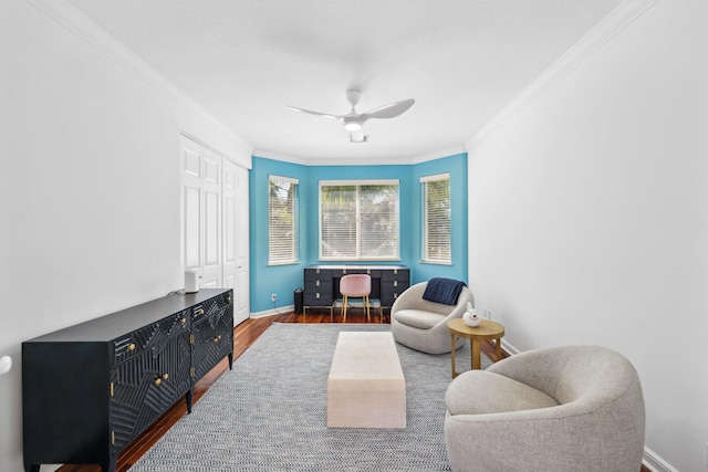 living area featuring crown molding, baseboards, ceiling fan, and wood finished floors
