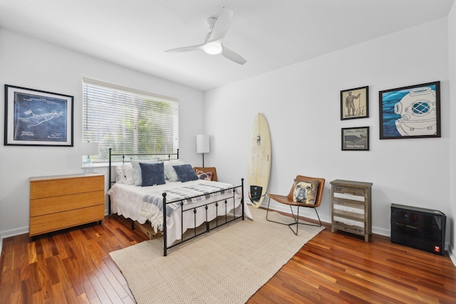 bedroom featuring baseboards, ceiling fan, and wood finished floors