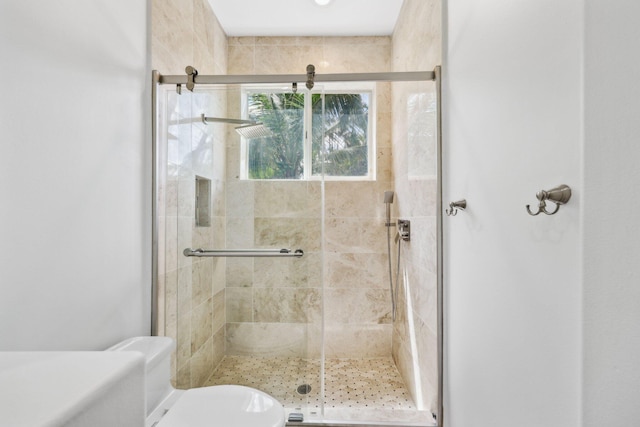 full bath with a shower stall and toilet