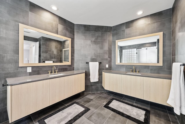 bathroom with vanity and tile walls