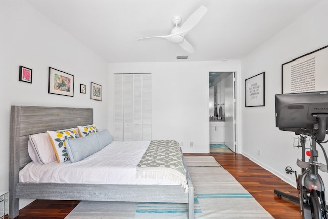bedroom with visible vents, baseboards, connected bathroom, wood finished floors, and a ceiling fan