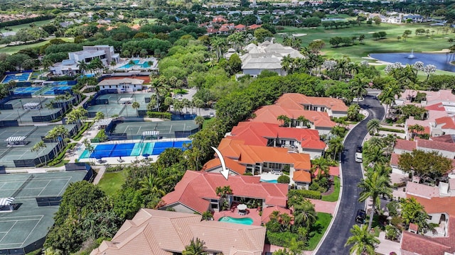 drone / aerial view featuring view of golf course and a residential view