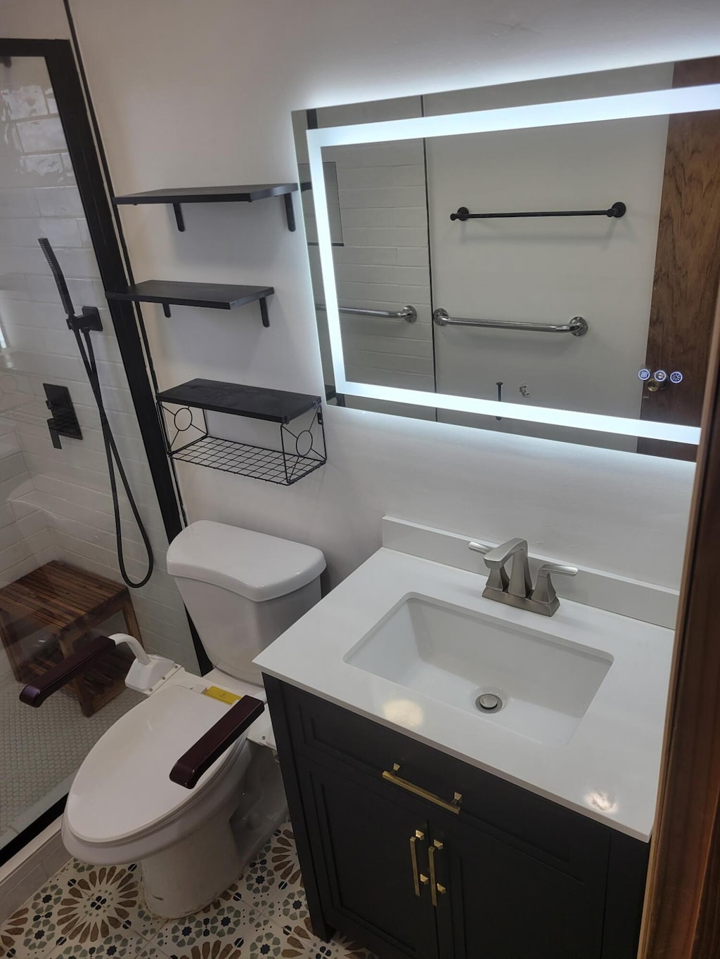 bathroom with vanity, a tile shower, and toilet