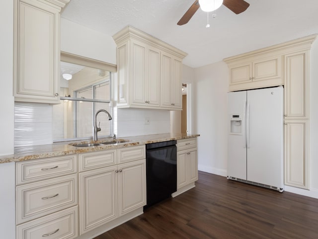 kitchen with dark wood-type flooring, white refrigerator with ice dispenser, cream cabinets, a sink, and dishwasher