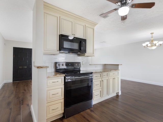 kitchen with dark wood finished floors, black appliances, cream cabinets, and decorative backsplash