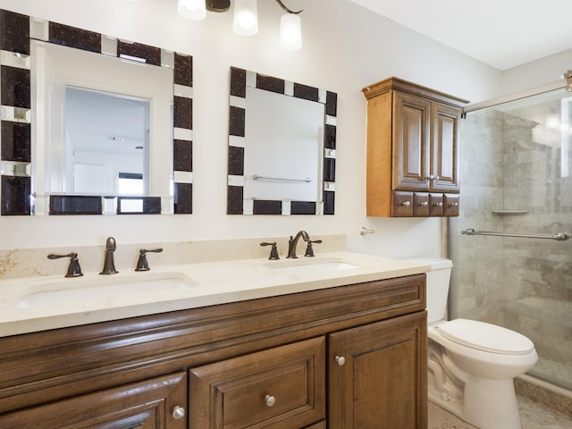 full bathroom featuring toilet, a sink, double vanity, and a shower stall
