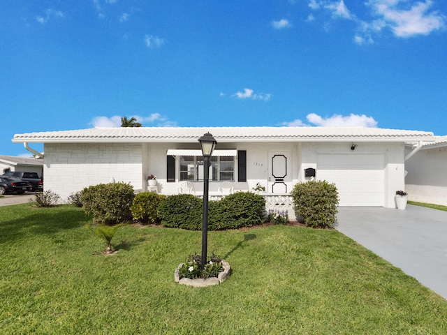 single story home with a front yard, concrete driveway, stucco siding, and an attached garage