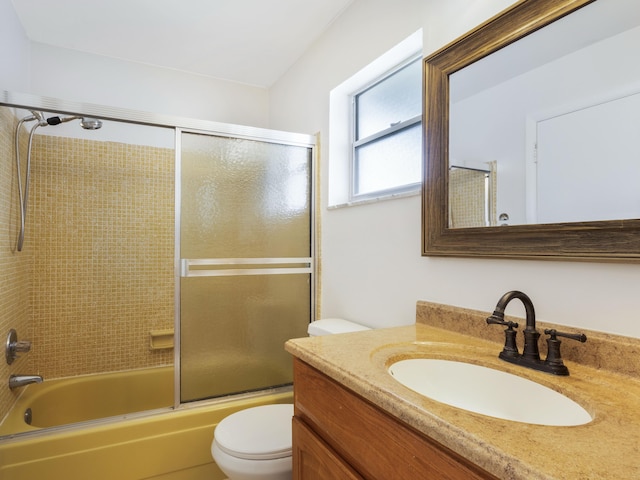 full bath with toilet, vanity, and enclosed tub / shower combo