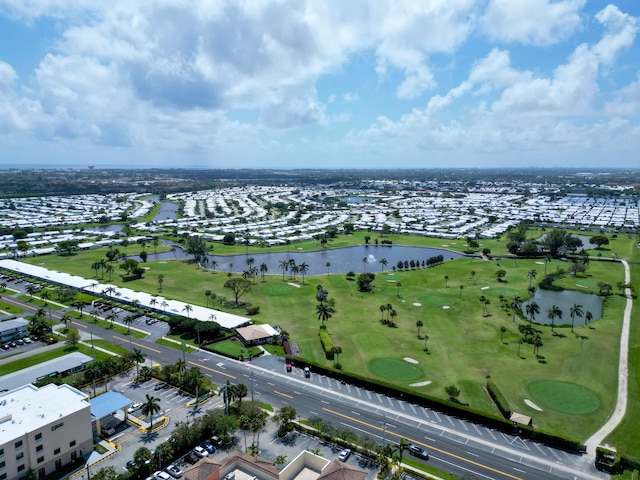 drone / aerial view featuring view of golf course and a water view