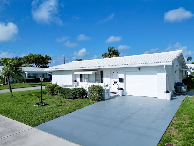 single story home featuring concrete driveway, an attached garage, a tiled roof, central AC unit, and a front lawn