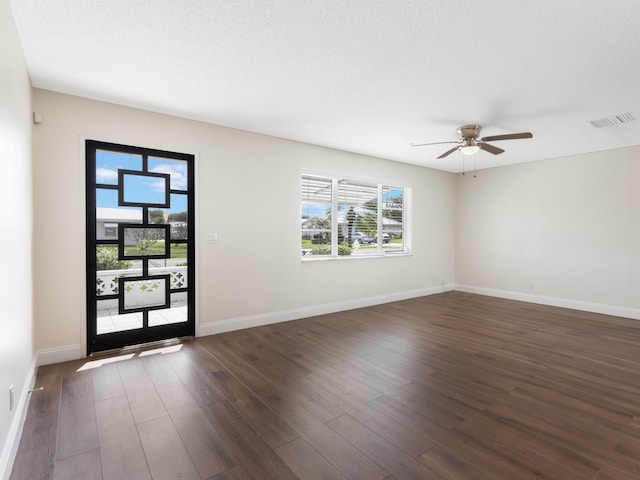 foyer with a ceiling fan, dark wood-type flooring, baseboards, and visible vents