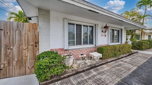317 SE 12th Ave Unit 1-2, Pompano Beach, FL 33060 - view of property exterior with fence and brick siding