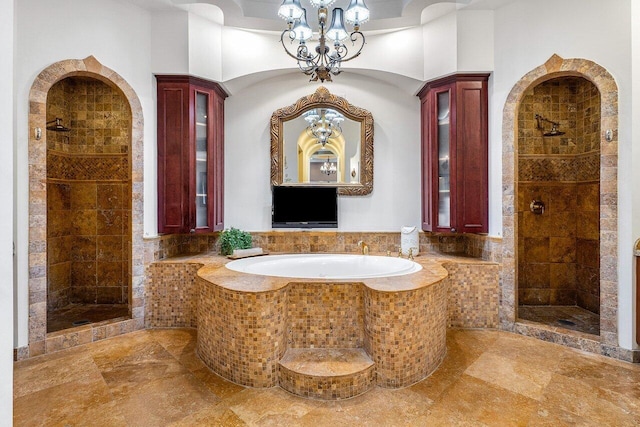 full bath with a bath and a shower stall