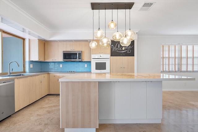 4800 Harrison St, Hollywood, FL 33021 - kitchen featuring stainless steel appliances, light brown cabinets, a sink, crown molding, and tasteful backsplash