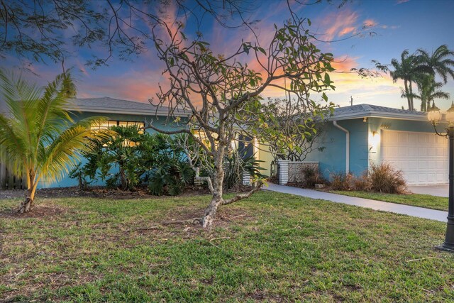 4800 Harrison St, Hollywood, FL 33021 - view of front of home featuring a garage, a lawn, and stucco siding