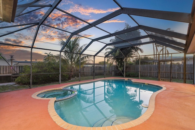4800 Harrison St, Hollywood, FL 33021 - pool at dusk with a fenced backyard, a pool with connected hot tub, a patio area, and a lanai