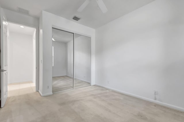 unfurnished bedroom featuring visible vents, baseboards, a closet, and carpet floors