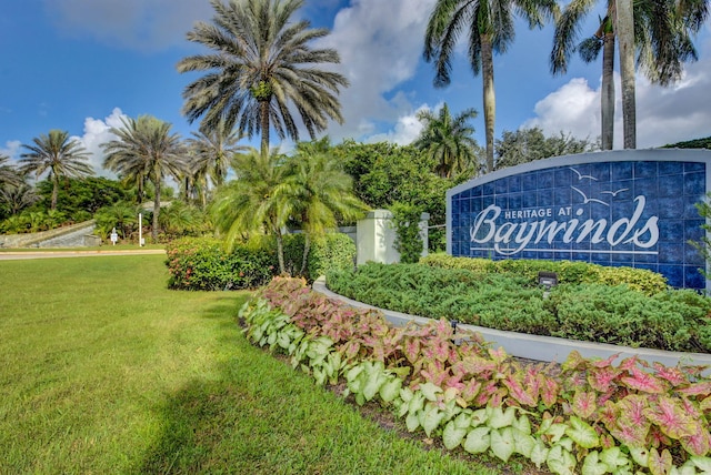 community / neighborhood sign with a yard