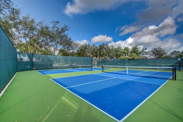 view of tennis court featuring fence