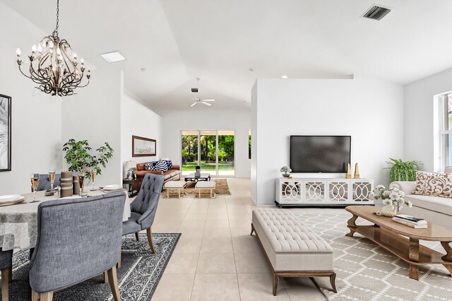 unfurnished room with light tile patterned floors, ceiling fan with notable chandelier, and visible vents