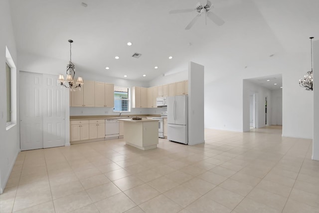 kitchen featuring ceiling fan with notable chandelier, white appliances, visible vents, a center island, and light countertops