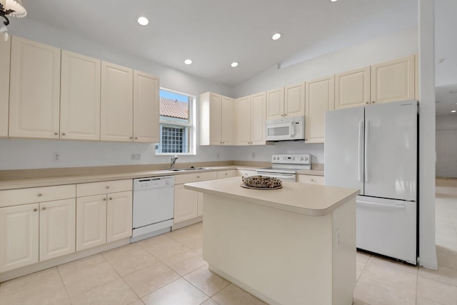 kitchen featuring light countertops, light tile patterned floors, a sink, and white appliances