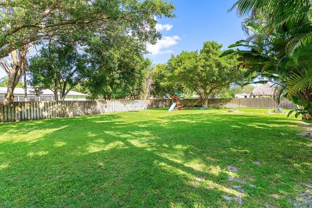 267 Old Country Rd S, Wellington, FL 33414 - view of yard featuring a fenced backyard and a playground
