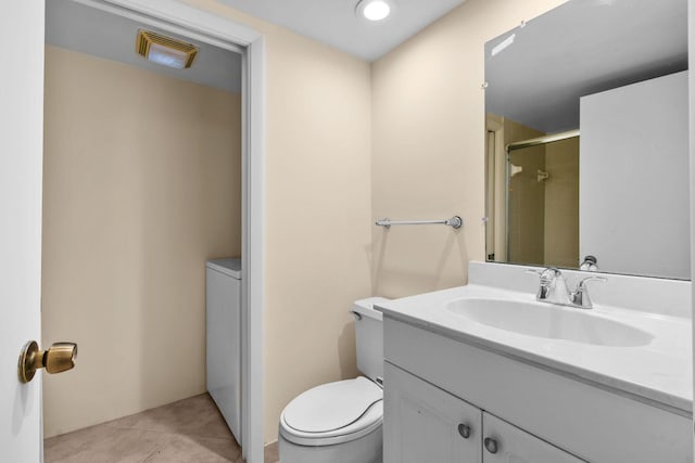 full bath featuring toilet, vanity, a shower with shower door, tile patterned floors, and washer / dryer