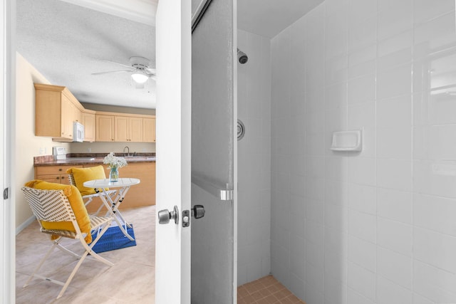 3203 Meridian Way N Unit D, Palm Beach Gardens, FL 33410 - full bathroom featuring a stall shower, ceiling fan, and a sink