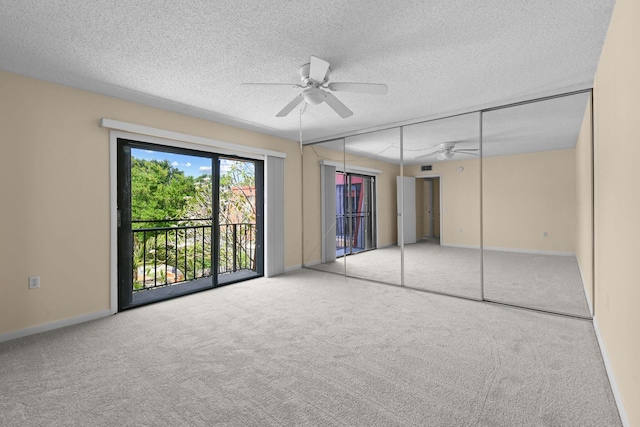 3203 Meridian Way N Unit D, Palm Beach Gardens, FL 33410 - unfurnished bedroom with carpet floors, access to exterior, a textured ceiling, baseboards, and a ceiling fan