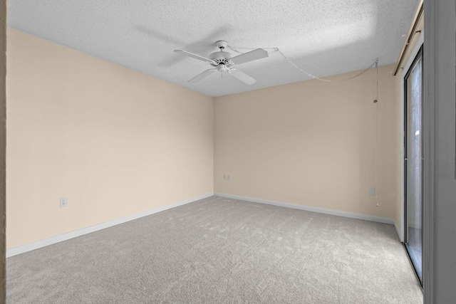 unfurnished room featuring carpet floors, a textured ceiling, ceiling fan, and baseboards