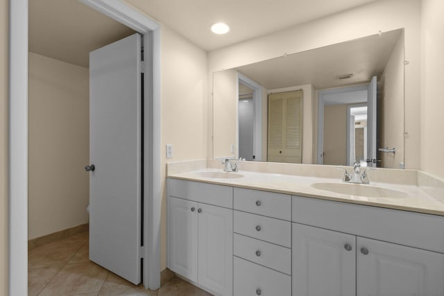 3203 Meridian Way N Unit D, Palm Beach Gardens, FL 33410 - bathroom featuring double vanity, tile patterned floors, baseboards, and a closet
