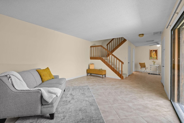 3203 Meridian Way N Unit D, Palm Beach Gardens, FL 33410 - living room featuring stairs, light tile patterned floors, a textured ceiling, and a ceiling fan