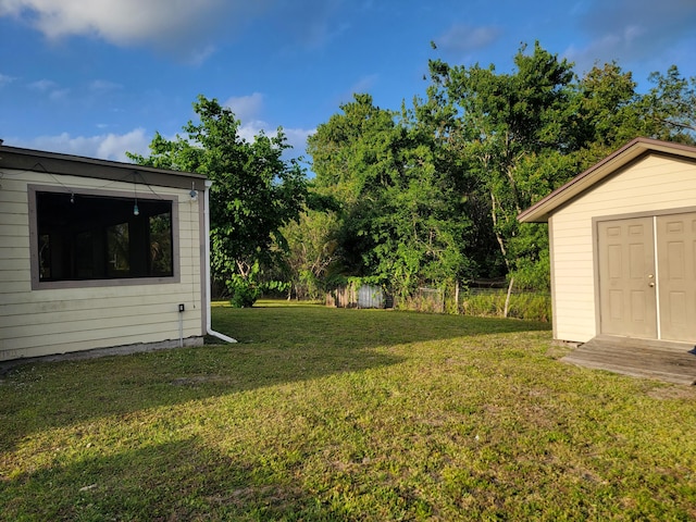 view of yard featuring a storage unit and an outdoor structure
