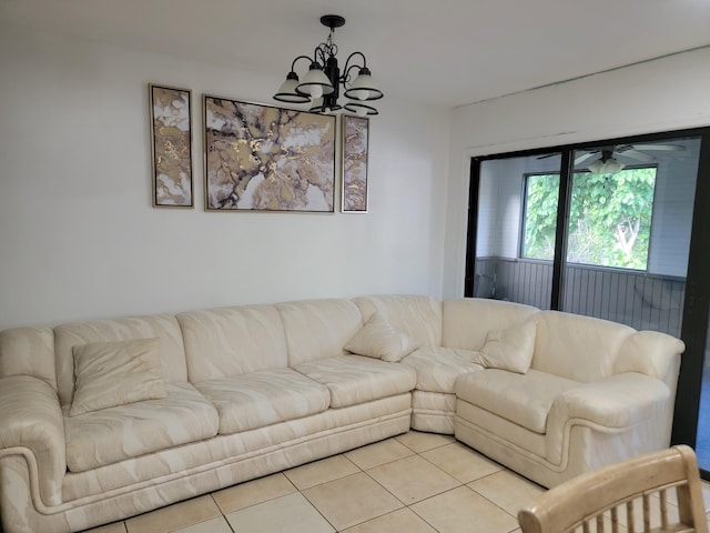 living area with a chandelier and light tile patterned floors