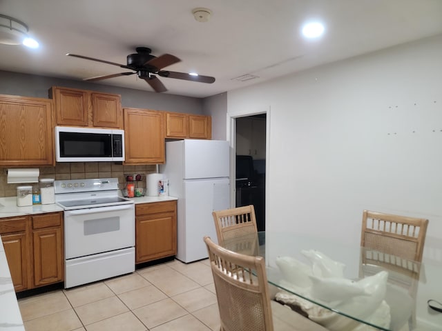 kitchen with light countertops, white appliances, ceiling fan, tasteful backsplash, and light tile patterned floors
