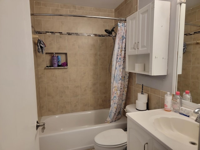 full bathroom featuring toilet, backsplash, vanity, shower / bath combo, and tile walls