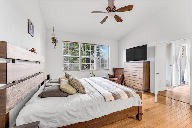 bedroom with a ceiling fan, light wood-style flooring, and lofted ceiling