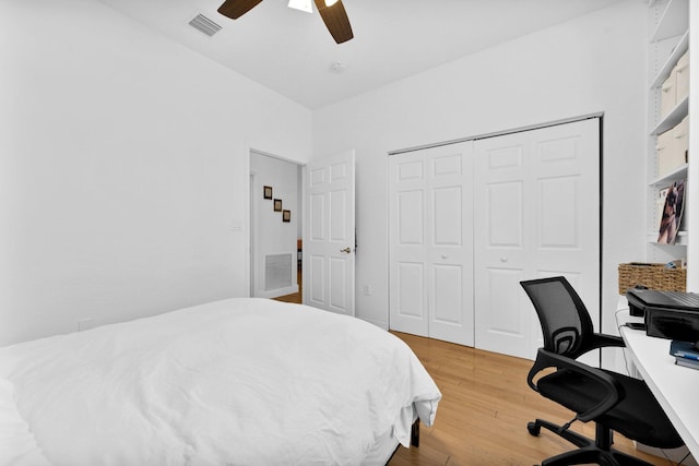 bedroom with ceiling fan, a closet, light wood finished floors, and visible vents